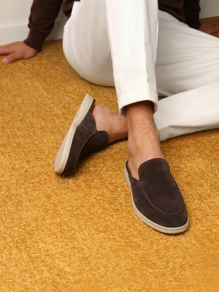 Tan men's casual slip-on mules with elegant stitching and comfortable open heel. A summer fashion essential.