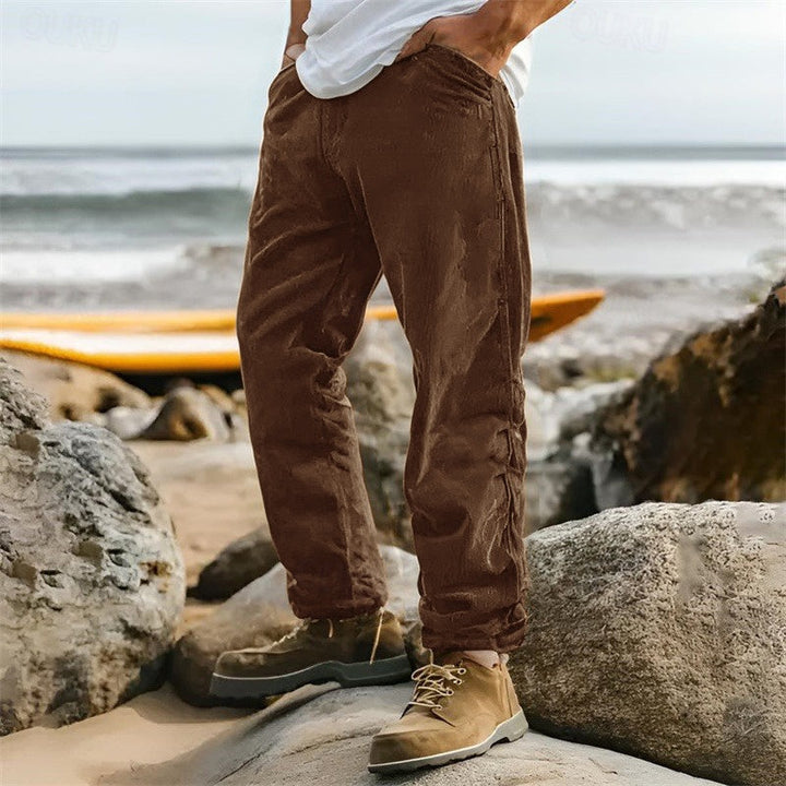 Versatile men's straight leg ribbed pants in a neutral color, great for comfortable everyday outfits and smart casual looks.