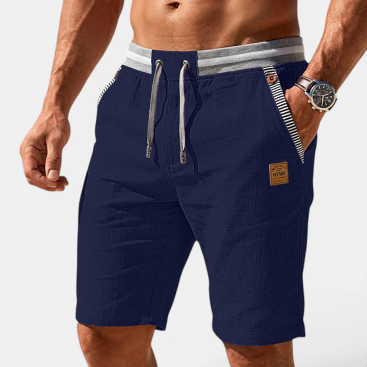 Comfortable men's shorts with an elastic waist & drawstring, ideal for casual summer days & beachwear.