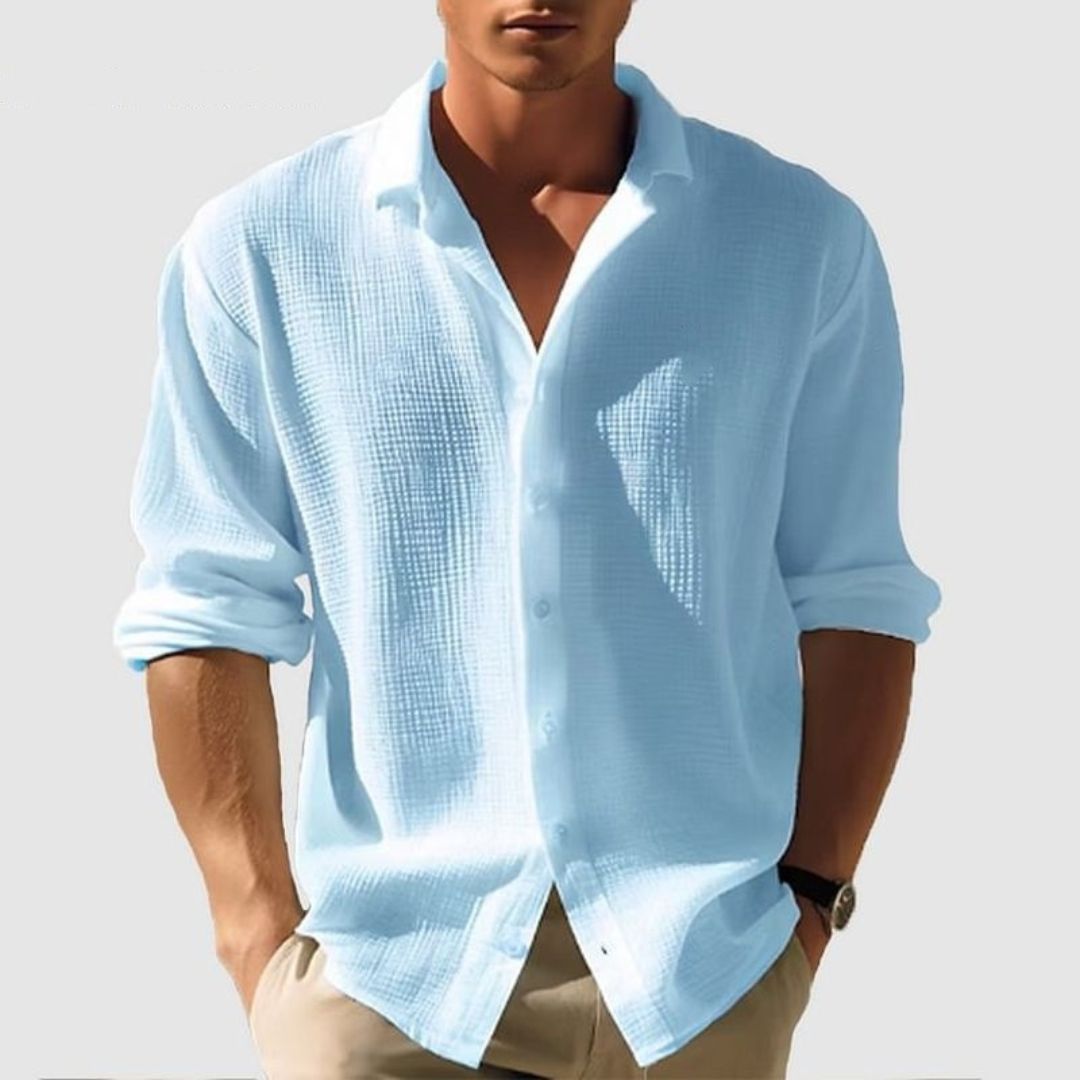Close-up of a men's casual textured long sleeve shirt, showcasing fabric detail & button-down style.