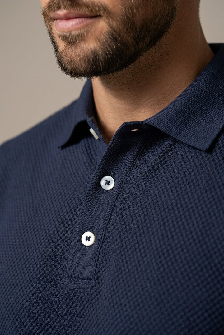 Comfortable men's textured two-piece outfit with polo and drawstring shorts for relaxed spring fashion.