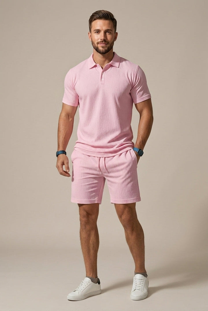 Man wearing a comfortable textured polo shirt and drawstring shorts set, suitable for relaxed summer days.