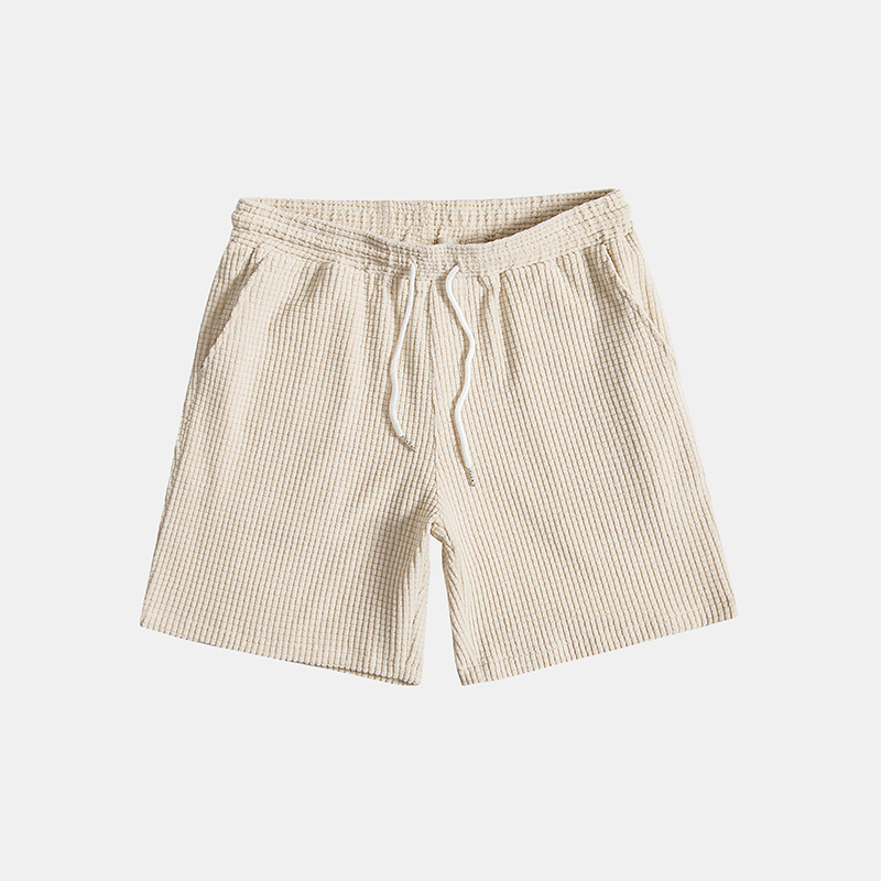 Men's two-piece summer outfit: casual button-up shirt & comfortable shorts. Great for beach style or vacation.