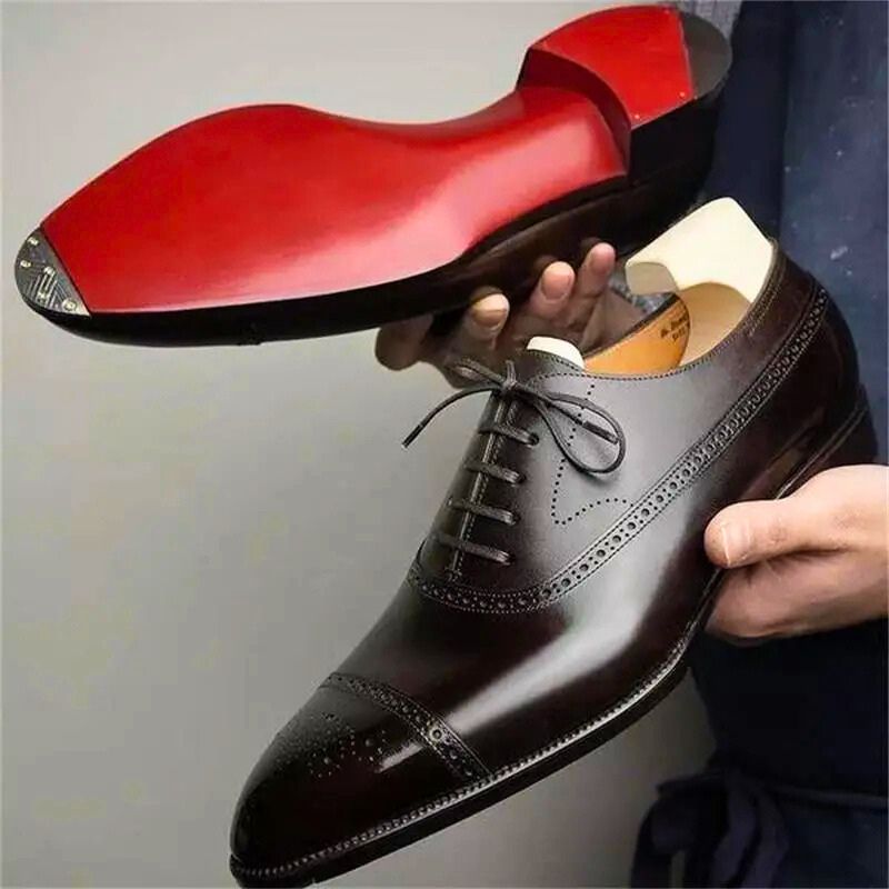 Men's classic black leather Oxford dress shoes with cap toe. Elegant lace-up formal footwear for refined style & comfort.