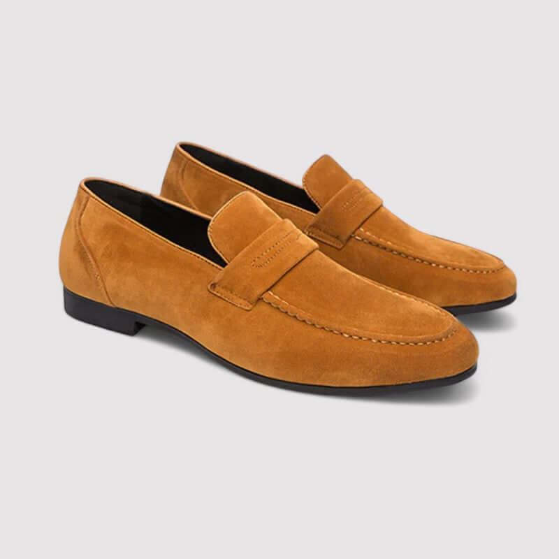 Polished men's leather penny loafers, featuring a classic slip-on design for enduring style and everyday comfort.