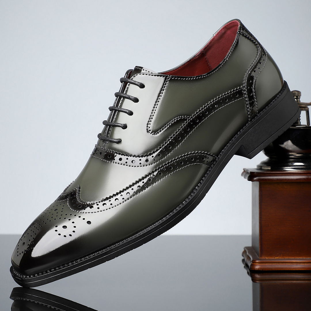 Close-up of polished black leather men's wingtip brogue dress shoes, highlighting craftsmanship and elegant formal details.