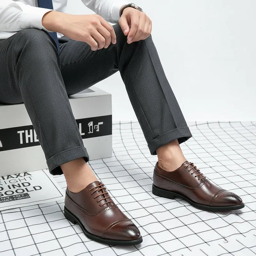 Classic black Oxford brogue dress shoes for men, a sophisticated choice for formal attire and weddings.