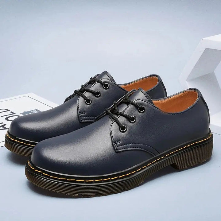 Polished leather men's Oxford shoes, perfect for professional business attire & sophisticated formal fashion.