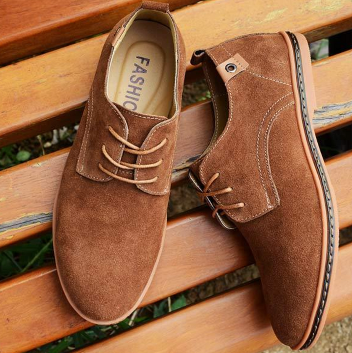 Stylish men's classic Oxford lace-up shoes on foot, delivering a sharp, professional business or wedding ensemble.