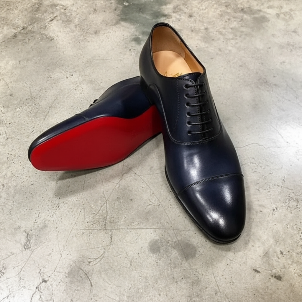 Elegant men's black Oxford shoes, perfect for business or formal events, featuring a distinctive red sole.