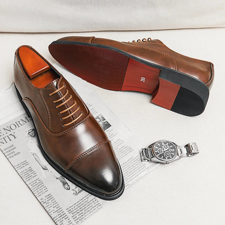 Close-up of men's elegant Oxford dress shoe detailing, premium leather, and the distinctive red sole.