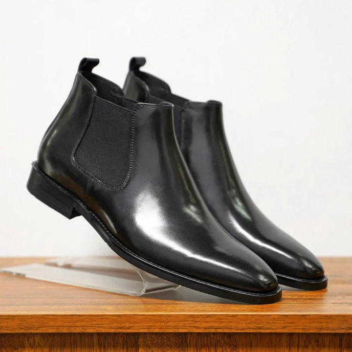 Classic men's black Chelsea boots. Slip-on style offers versatile footwear for both dressy and casual looks.