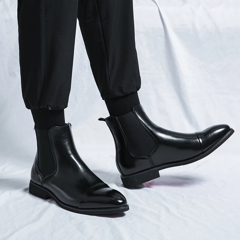 Men's classic brown leather Chelsea boots with cap toe design, perfect slip-on style for formal or casual wear.