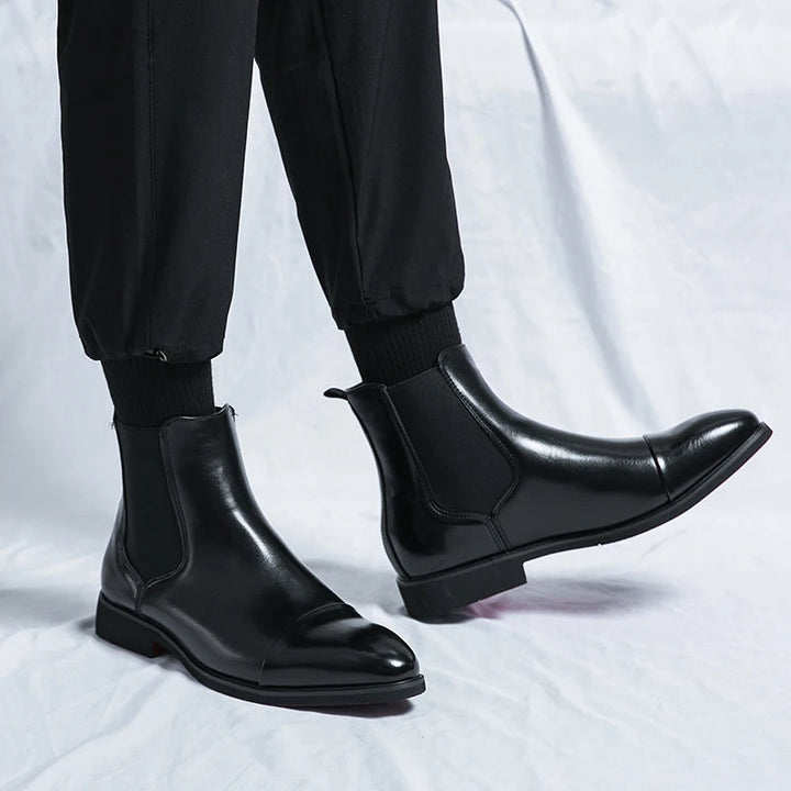 Men's classic brown leather Chelsea boots with cap toe design, perfect slip-on style for formal or casual wear.
