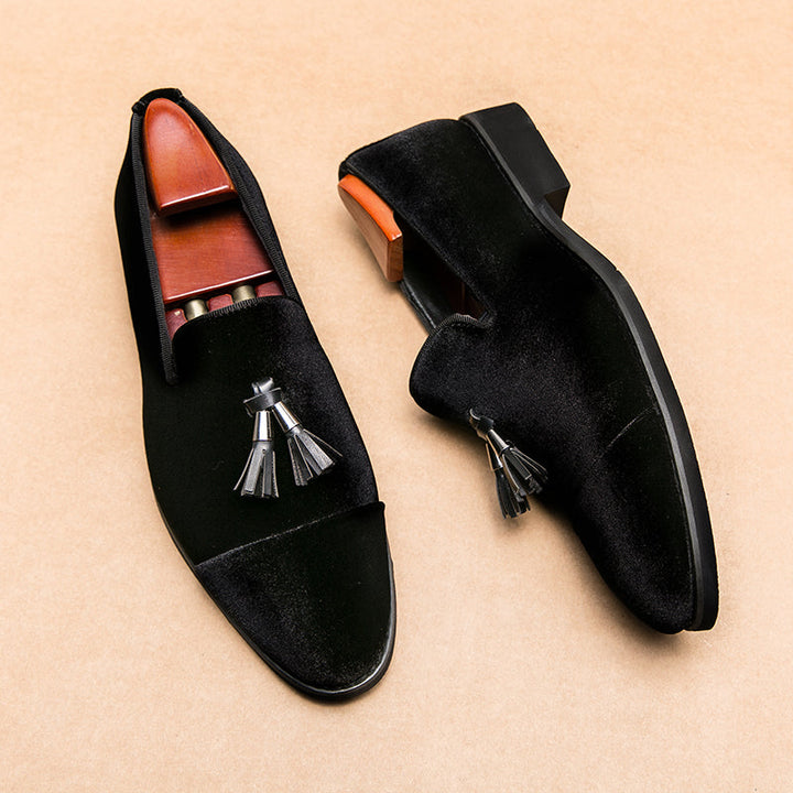Close-up of men's sleek leather tassel loafers. Detailed stitching & elegant design of formal slip-on shoes.