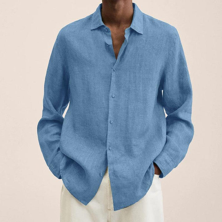 Detail of men's button down long sleeve shirt, featuring classic collar and functional buttons for summer.