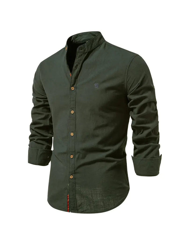 Man confidently walking in a casual long sleeve button-down shirt, a comfortable and stylish menswear option.