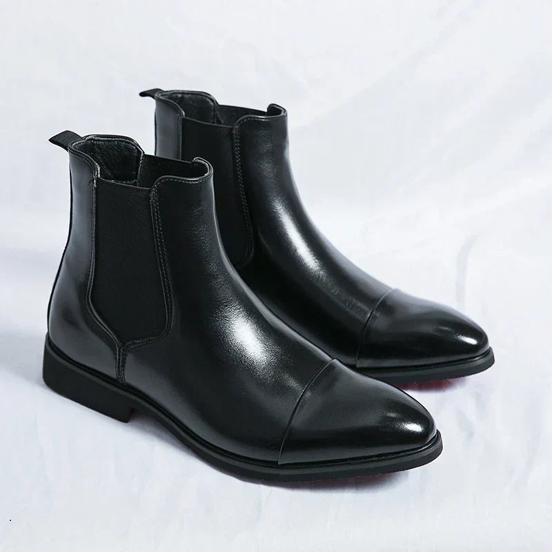 Sleek black leather men's cap toe Chelsea ankle boots, comfortable pull-on design for modern fashion.