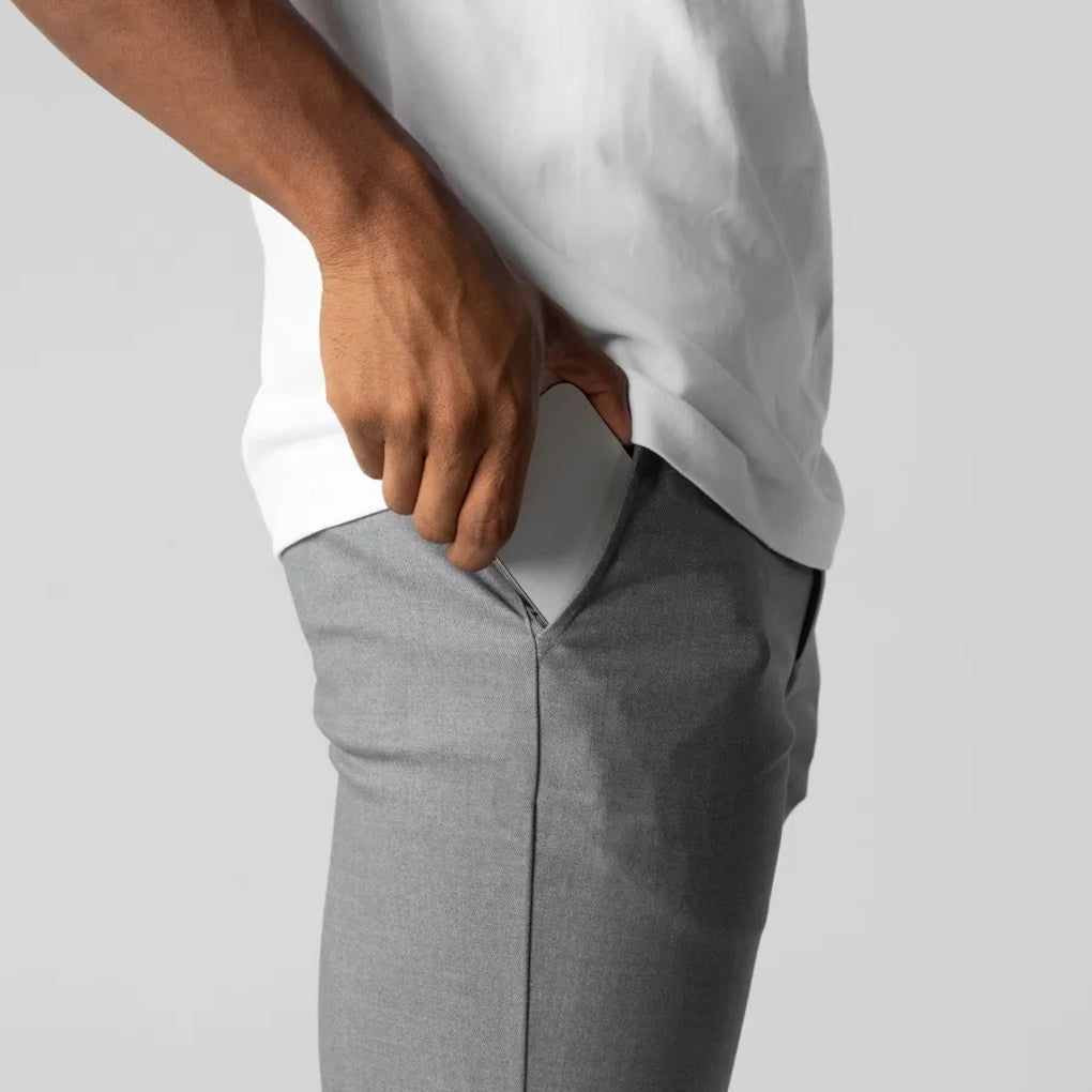 Man wearing classic fit grey chino pants with a casual shirt, demonstrating relaxed everyday menswear. Stylish & comfy.