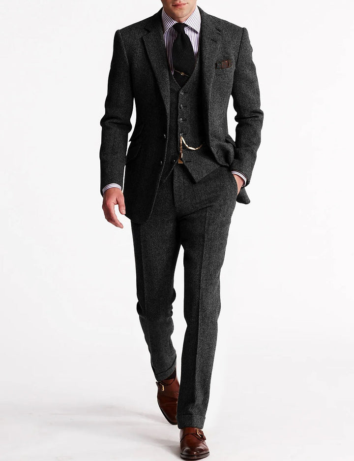 Men's classic three-piece formal suit featuring a refined vest and a decorative vest chain. Wedding & business attire.