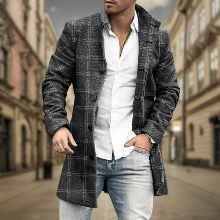 Sophisticated men's black winter coat. Longline design, elegant lapels, and button closure. Perfect outerwear.