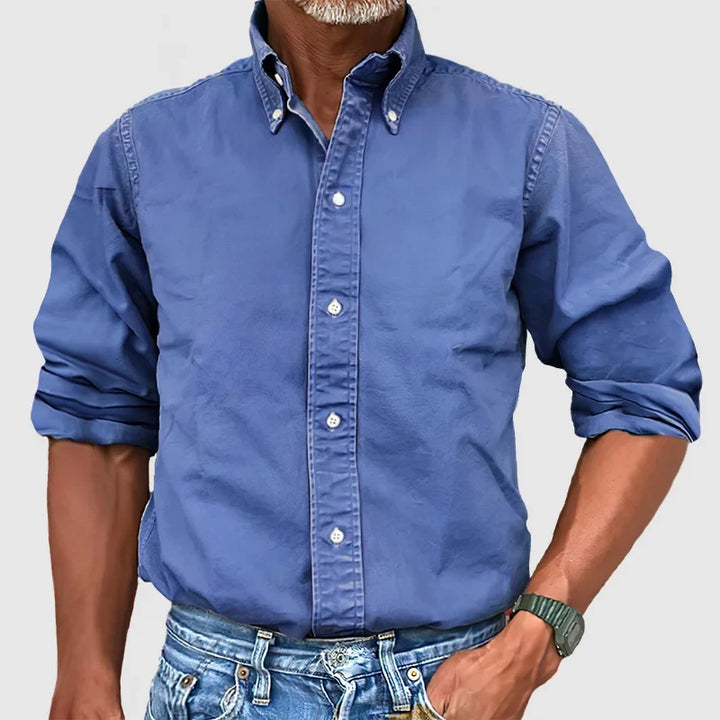 Details of a men's classic long-sleeve button-down shirt: collar, buttons, and quality fabric for versatile wear.
