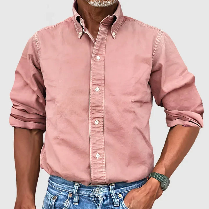 Man in a classic long-sleeve button-down shirt, styled for a refined business casual men's fashion look.