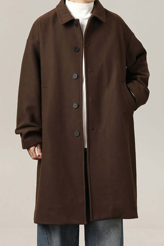 Men's classic oversized winter coat in a neutral color, perfect for layering & cold weather. Features a button closure.