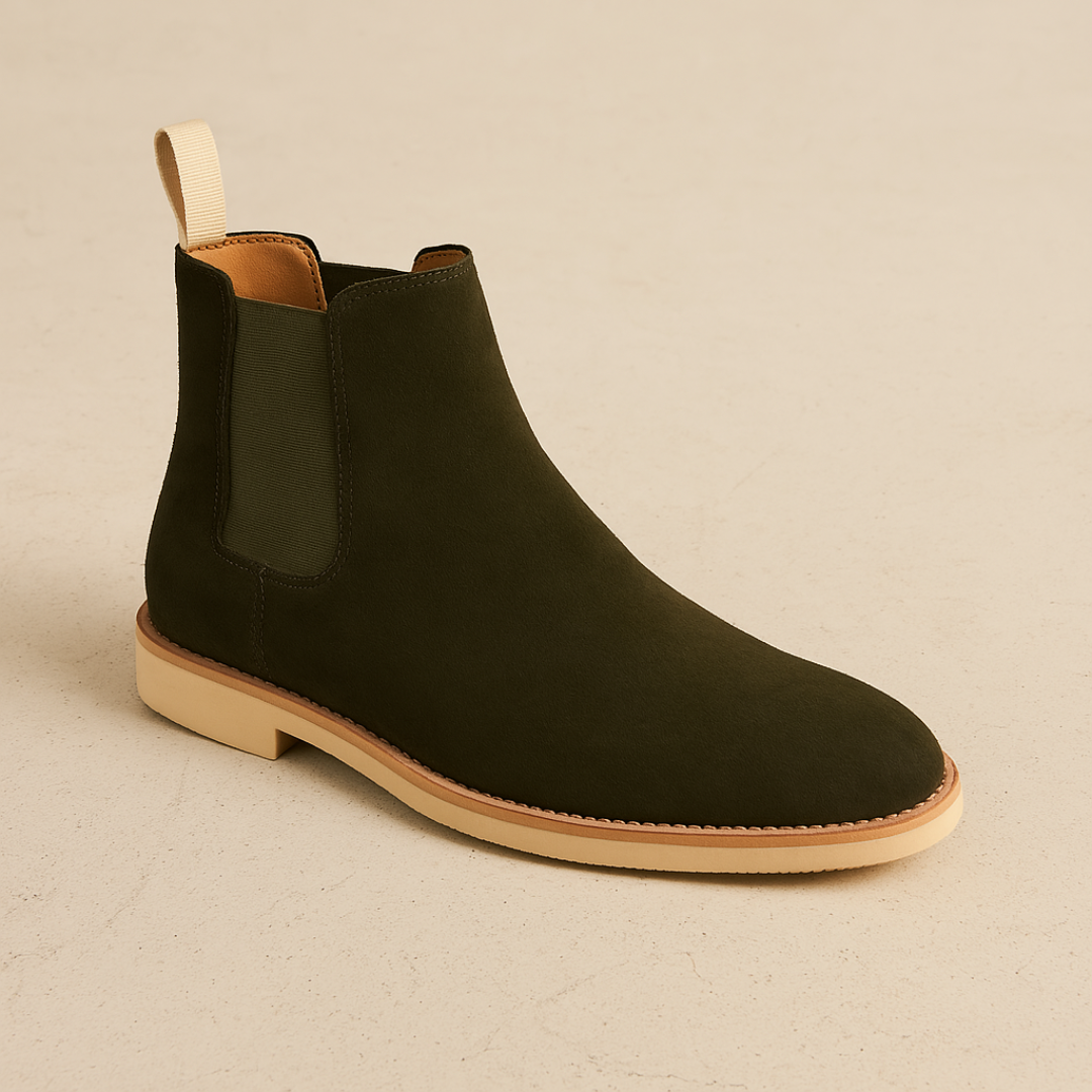 Man wearing classic black slip-on Chelsea boots, showcasing sleek design & all-season versatility.