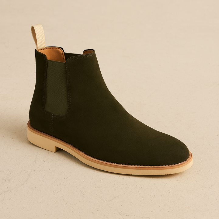 Man wearing classic black slip-on Chelsea boots, showcasing sleek design & all-season versatility.