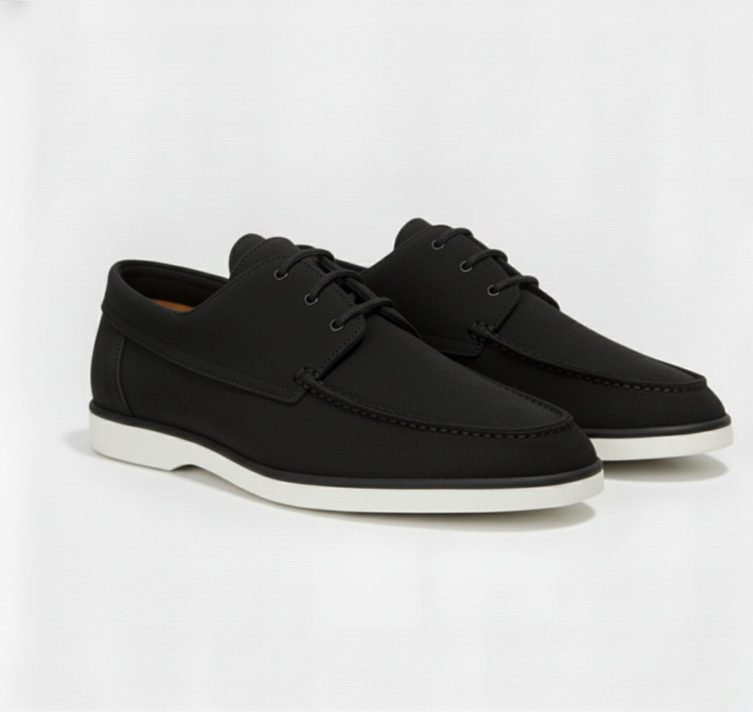 Detail shot of the refined top stitching on men's classic loafers, emphasizing quality & stylish men's footwear.
