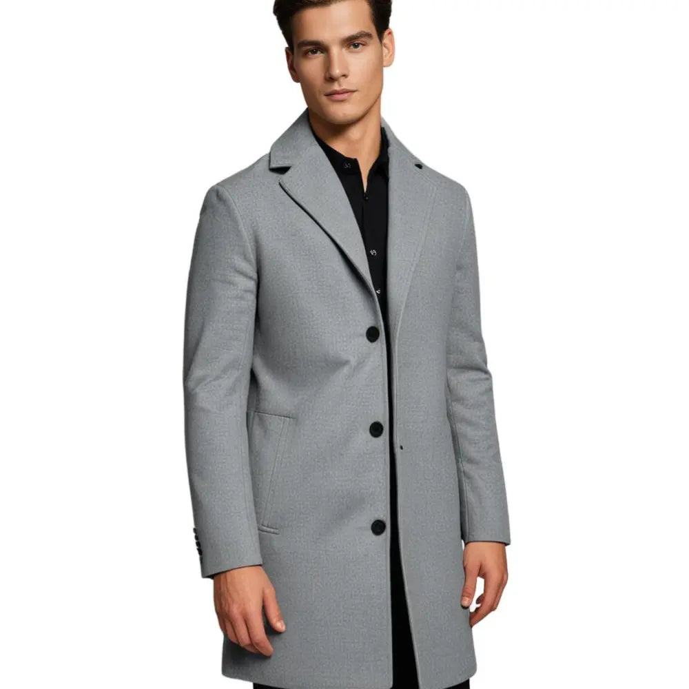 Man in a classic tailored long overcoat. Demonstrating smart casual men's winter fashion and layering.