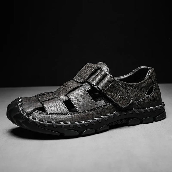 Side view of men's closed-toe brown leather fisherman sandals with hook-loop closure for comfort & outdoor walking.