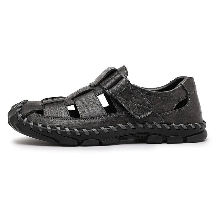 Top view of black men's closed-toe leather fisherman sandals, hook-loop design. Ideal for summer casual wear.