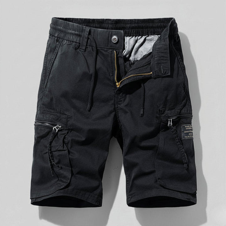 Close-up of men's utility cargo shorts showing multi-pocket design & comfortable elastic waist for work or casual.