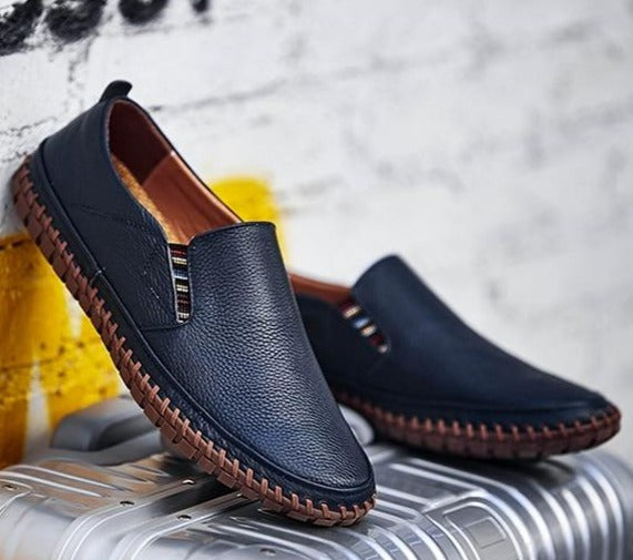 Close-up of flexible sole on men's slip-on walking shoes, designed for ultimate comfort & daily grip.