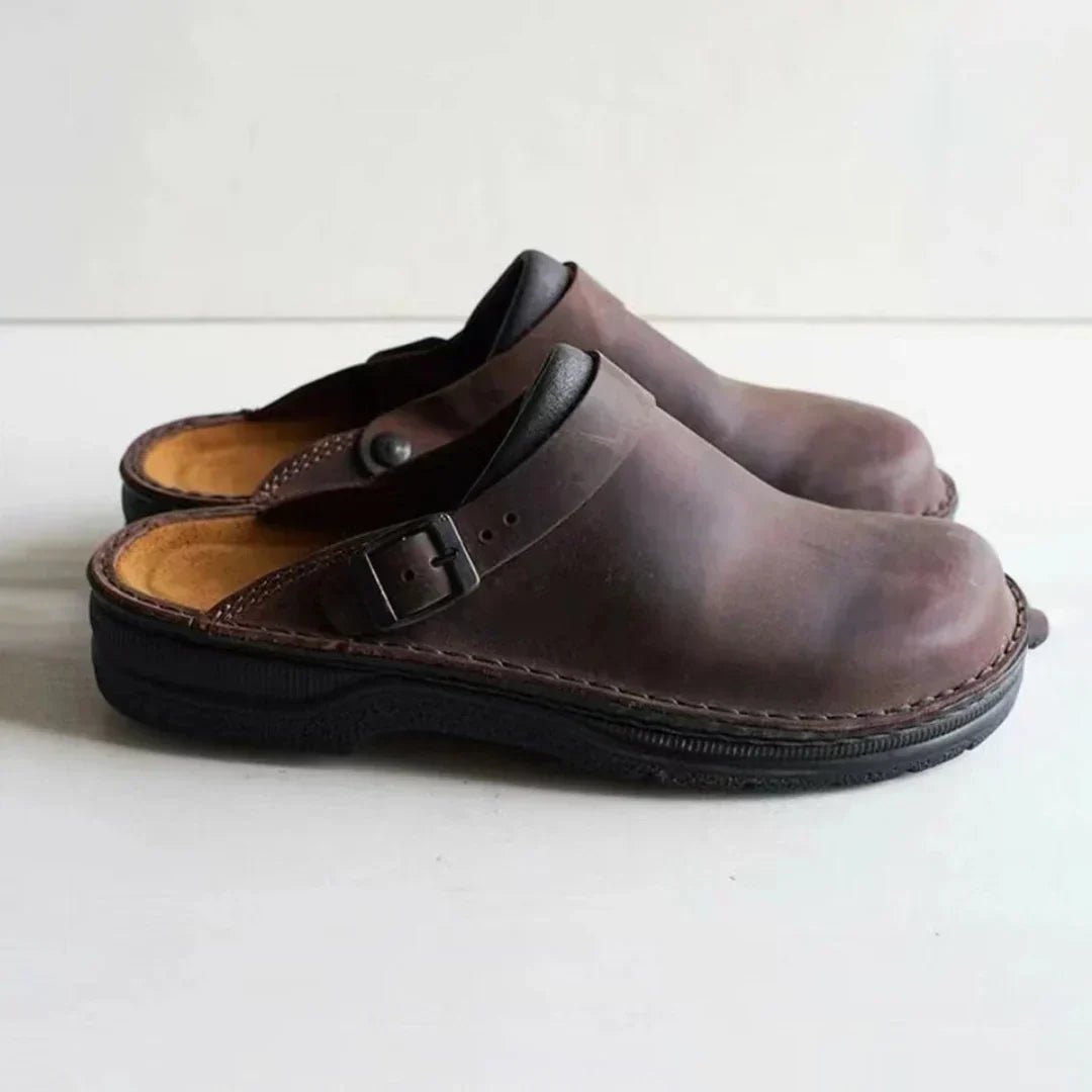 Easy slip-on men's clogs with a stylish buckle strap, offering comfortable & versatile casual footwear for men.