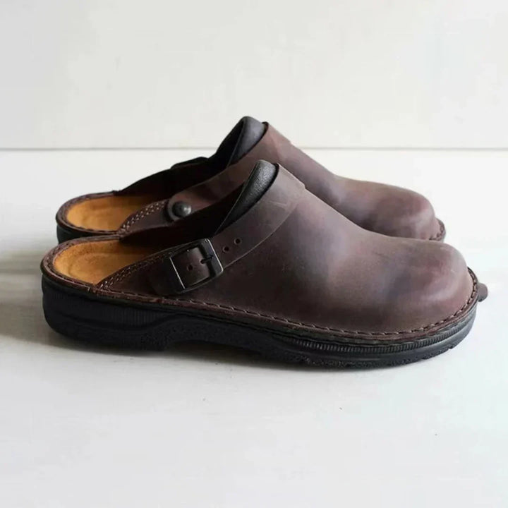 Easy slip-on men's clogs with a stylish buckle strap, offering comfortable & versatile casual footwear for men.