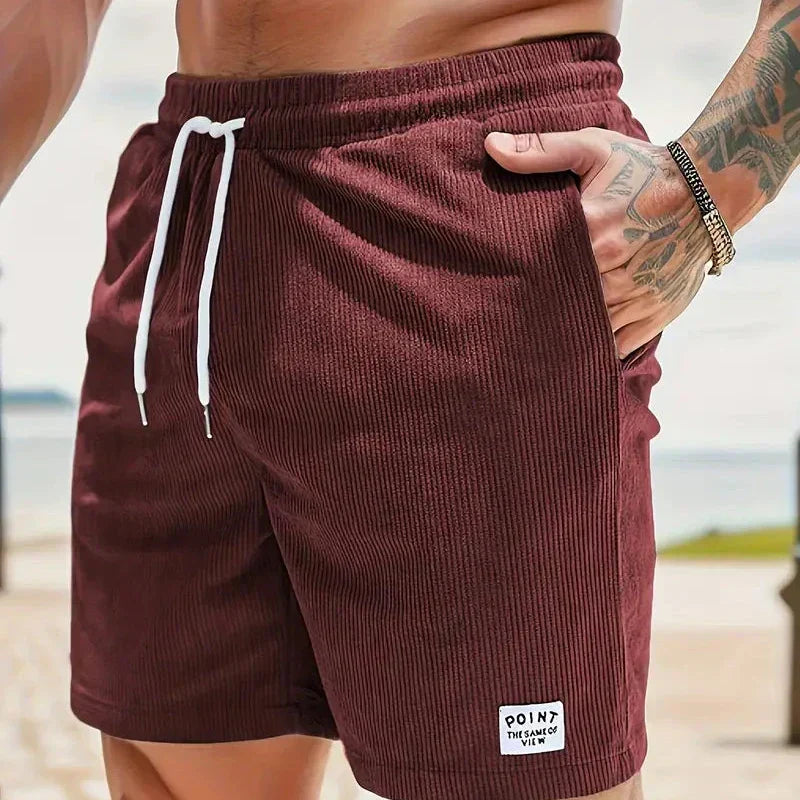 Man sitting comfortably in versatile men's casual shorts with a drawstring waist.