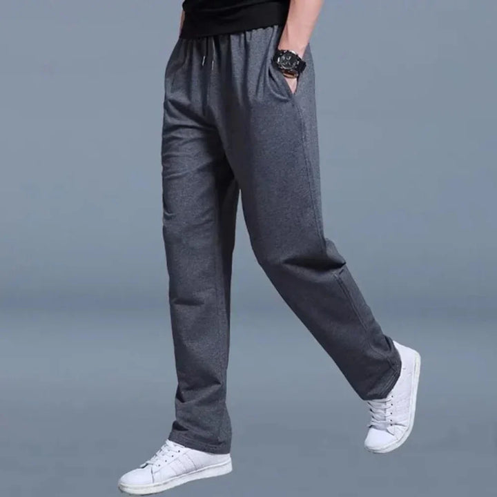Grey men's activewear pants, new comfortable joggers with relaxed fit for sport or leisure. Essential.