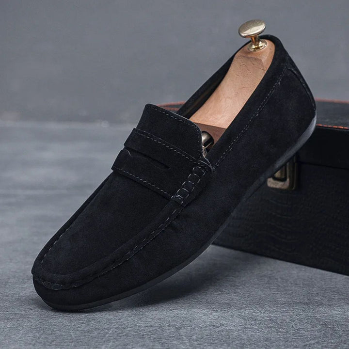 Stylish black men's slip-on driving loafers, ideal for relaxed fashion & easy wear.