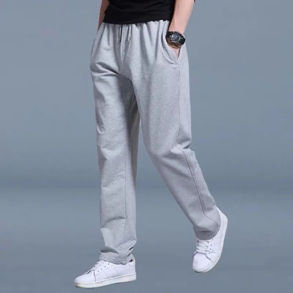 Grey men's comfort joggers, relaxed fit with elastic waist for ultimate lounge & casual style.