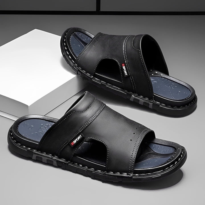 Stylish men's wide footbed slide sandals for ultimate comfort. Ideal casual slip-on summer footwear.