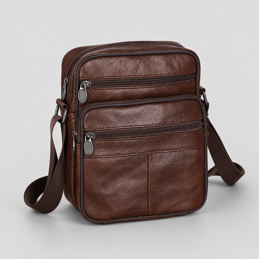 Organized men's compact leather messenger bag for daily essentials, features multiple compartments & adjustable strap.