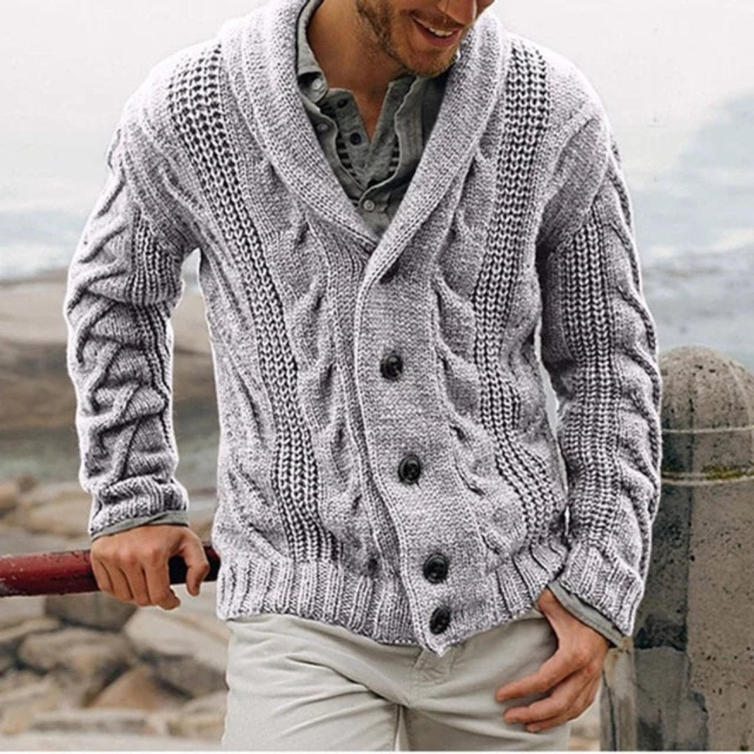 Detailed view of a men's cable knit cardigan jacket. Features a textured cable knit pattern & sophisticated shawl collar.