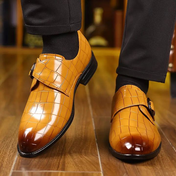Men's elegant slip-on loafers with a prominent crocodile pattern, tapered toe, and a secure buckle detail.