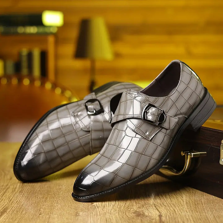 Elegant men's slip-on loafers, crocodile-textured, with a stylish buckle and a fashionable tapered toe design.