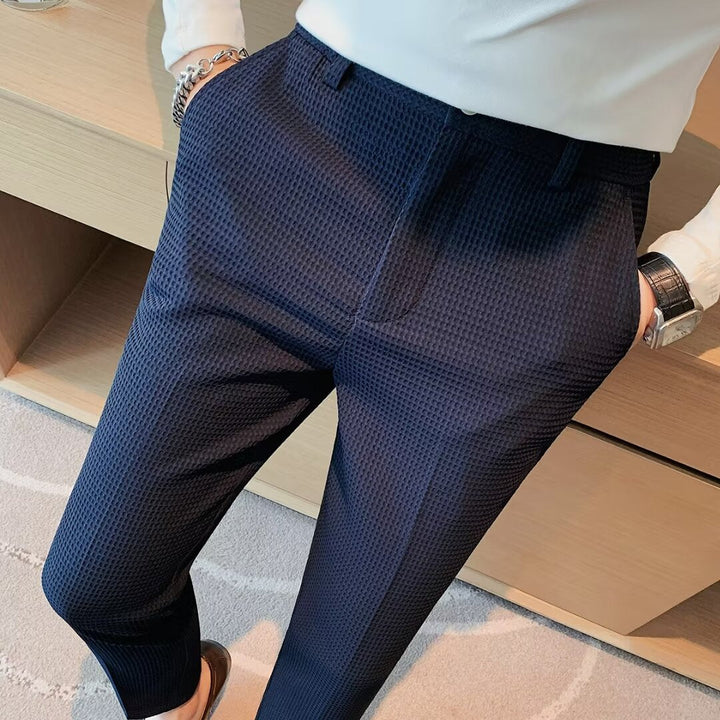 Close-up of men's modern slim fit cropped chinos, showcasing the contemporary cut and smart casual design.