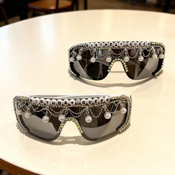 Close-up men's fashion sunglasses with intricate pearl & rhinestone embellishments. Glamour party wear, stylish UV protection.