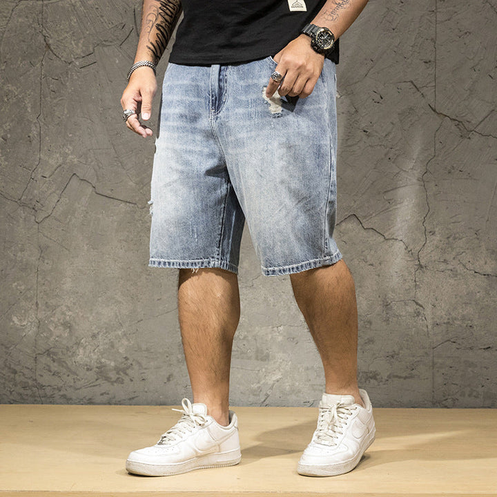 Men's distressed ripped light wash denim shorts, perfect for casual summer fashion and street style.